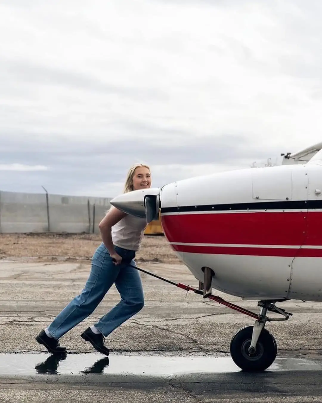 Woman pushing an aircraft