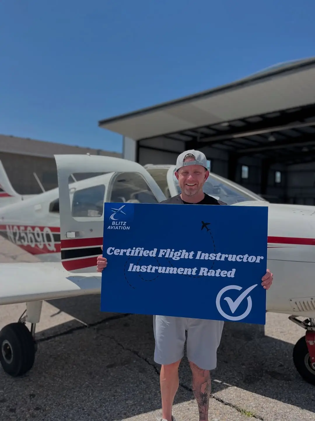 Student with CFII licence after a successful checkride in front of the aircraft.