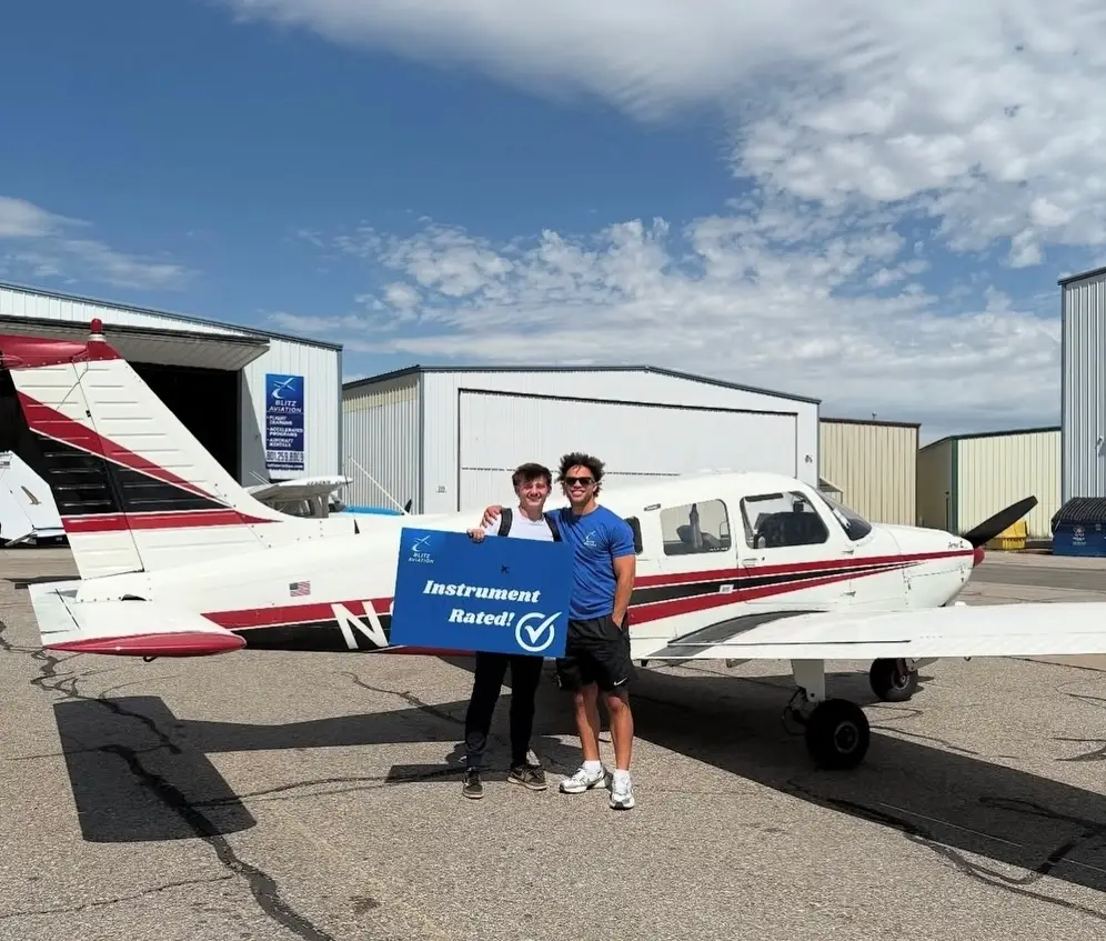 Student with CFII licence after a successful checkride in front of the aircraft.