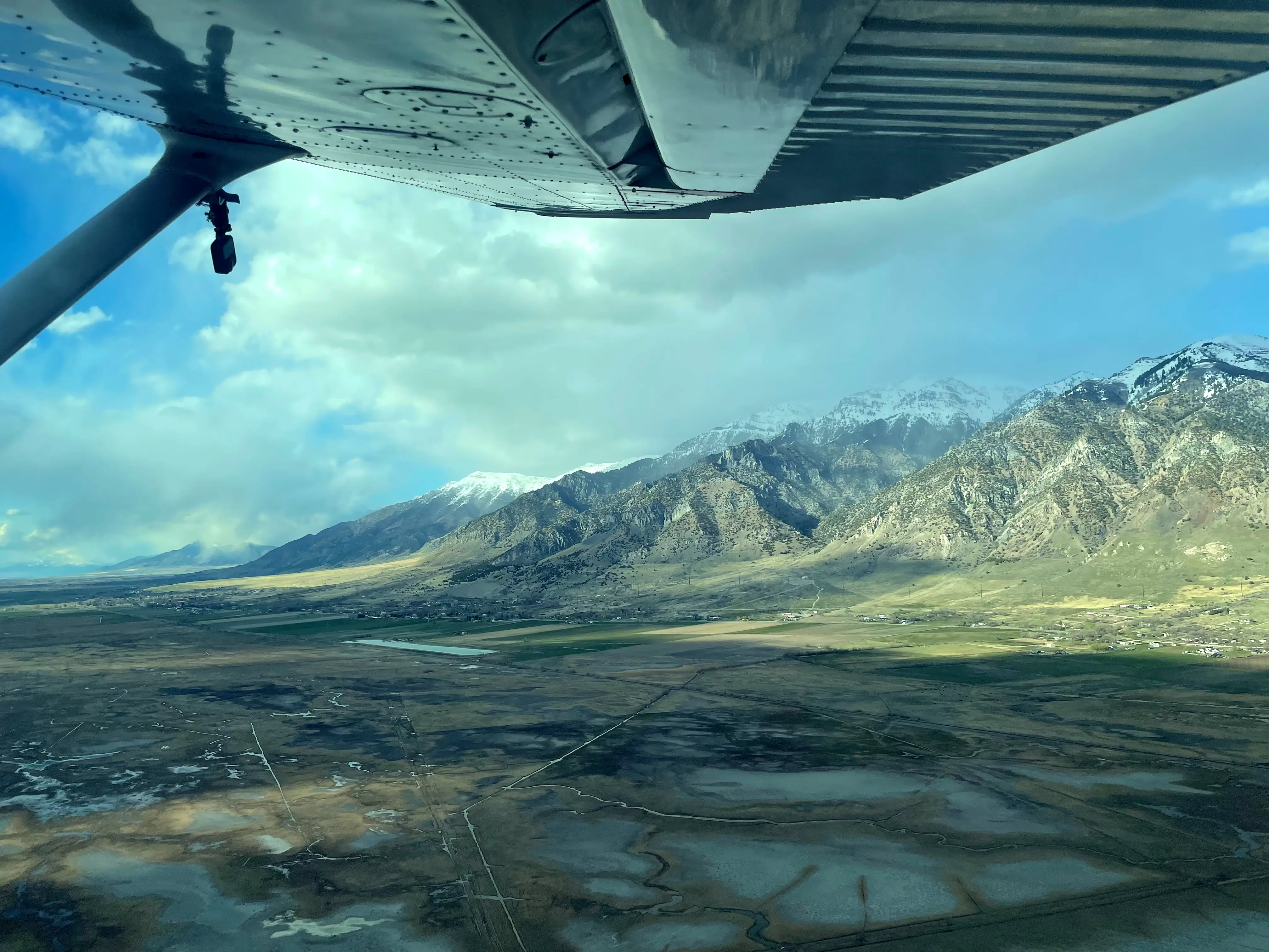 Student pilot view from cockpit during cross-country flight over Northern Utah terrain