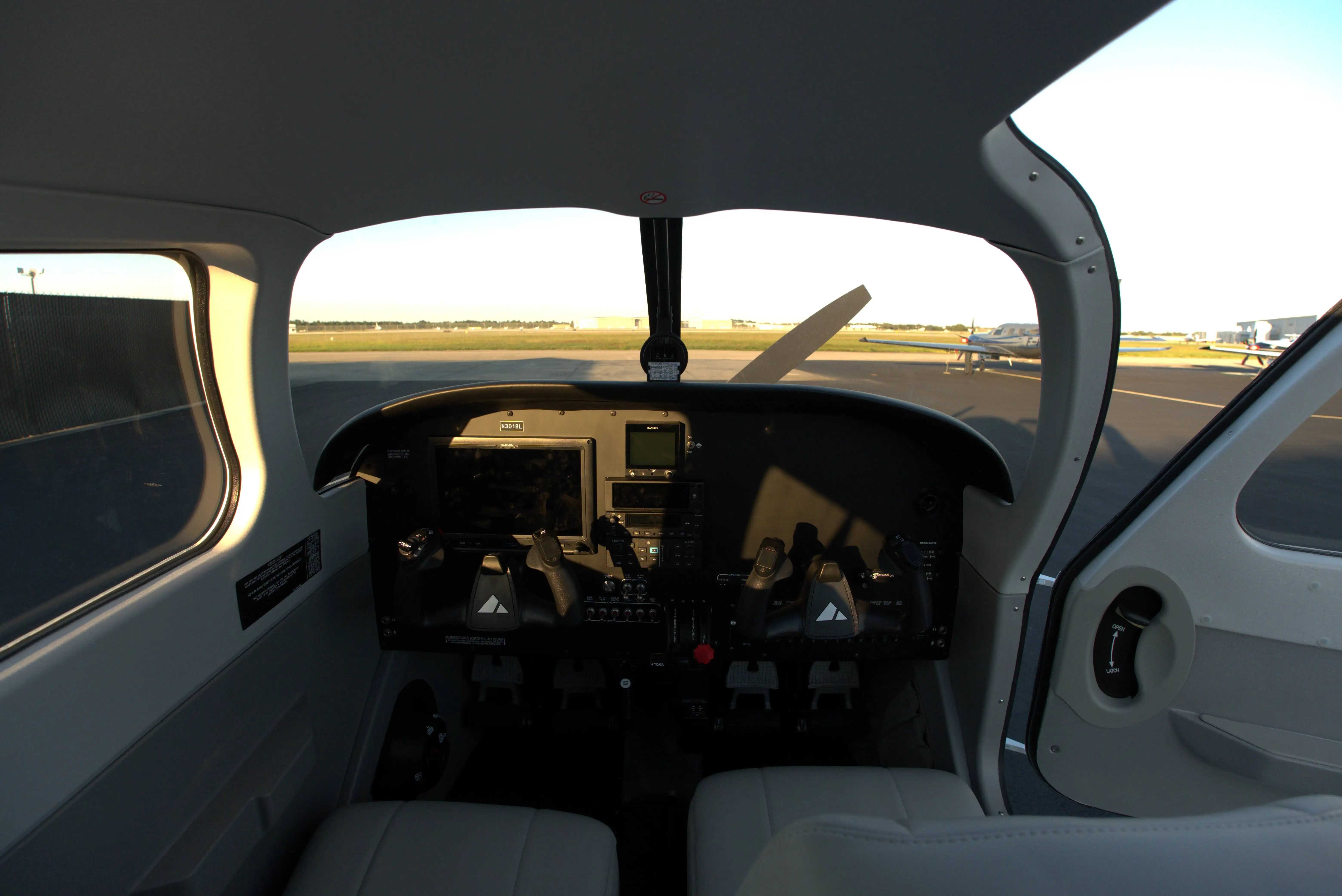 Cockpit of Piper Pilot 100i N301BL showing the Garmin glass panel and dual yokes