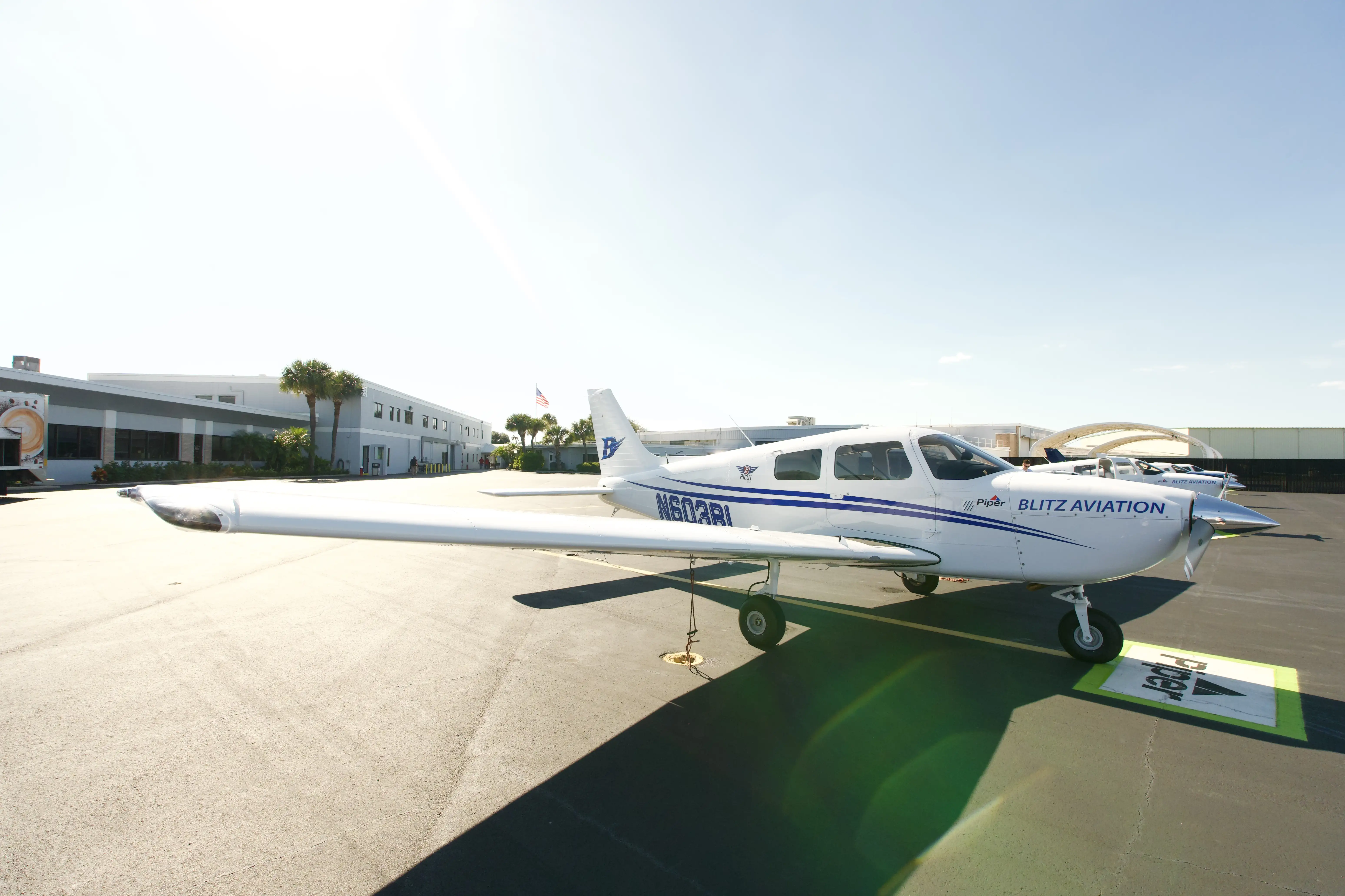 Piper Pilot 100i N603BL with Blitz Aviation and Piper lettering parked on a sunny ramp