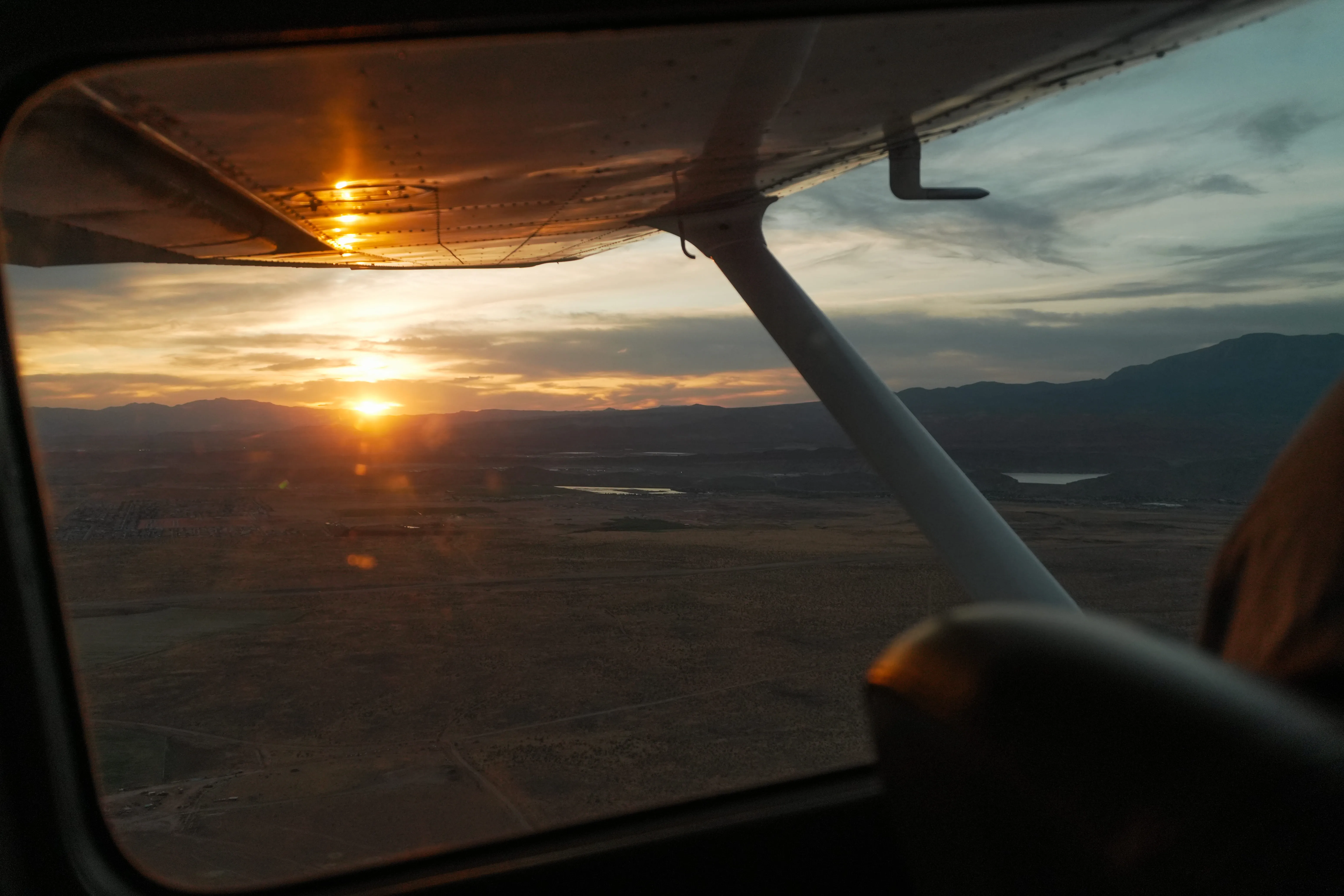Student and instructor wearing headsets in a Cessna cockpit during a flight lesson