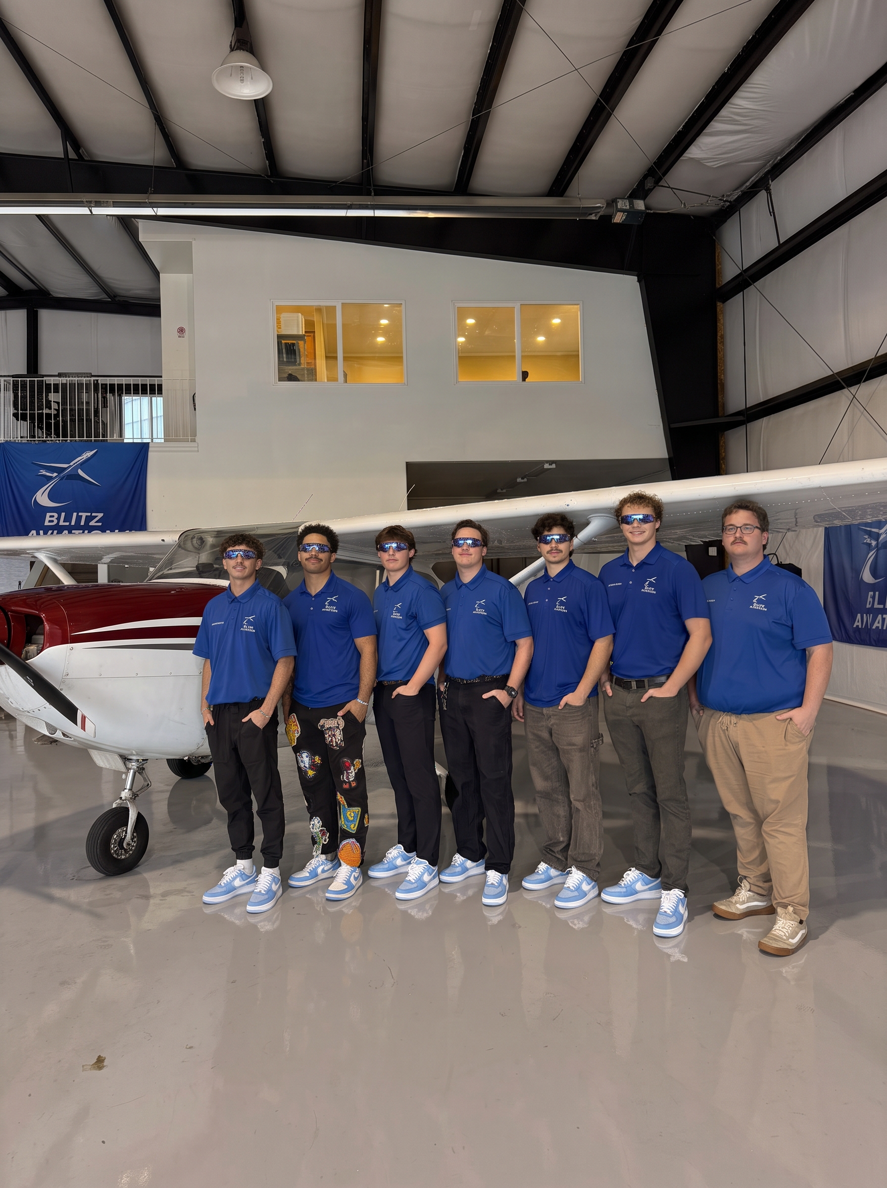 Blitz Aviation instructors and team gathered in front of a training airplane in Ogden, Utah